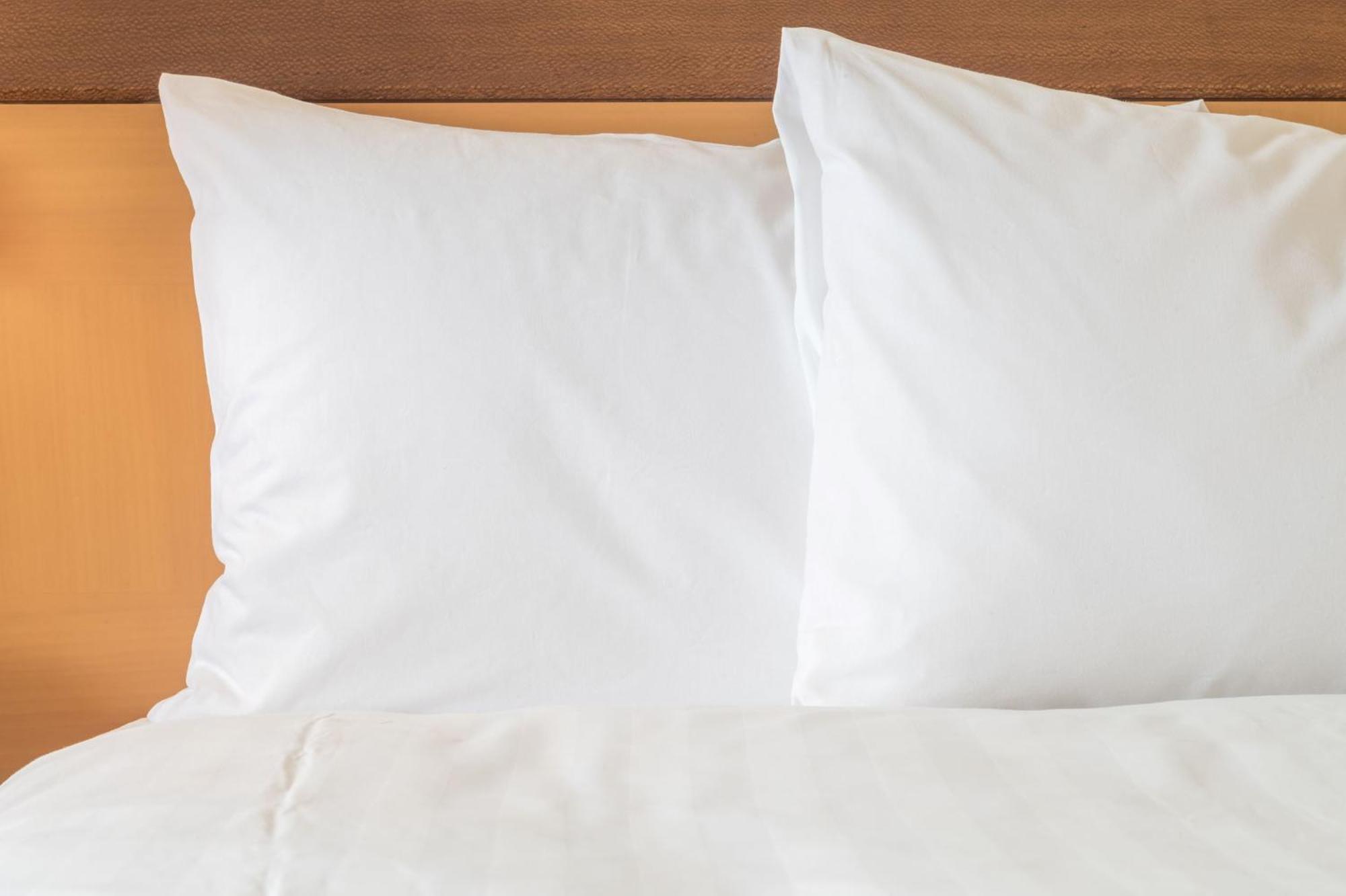 Ana Crowne Plaza Kobe By Ihg Hotel Exterior photo Two pillows on a bed
